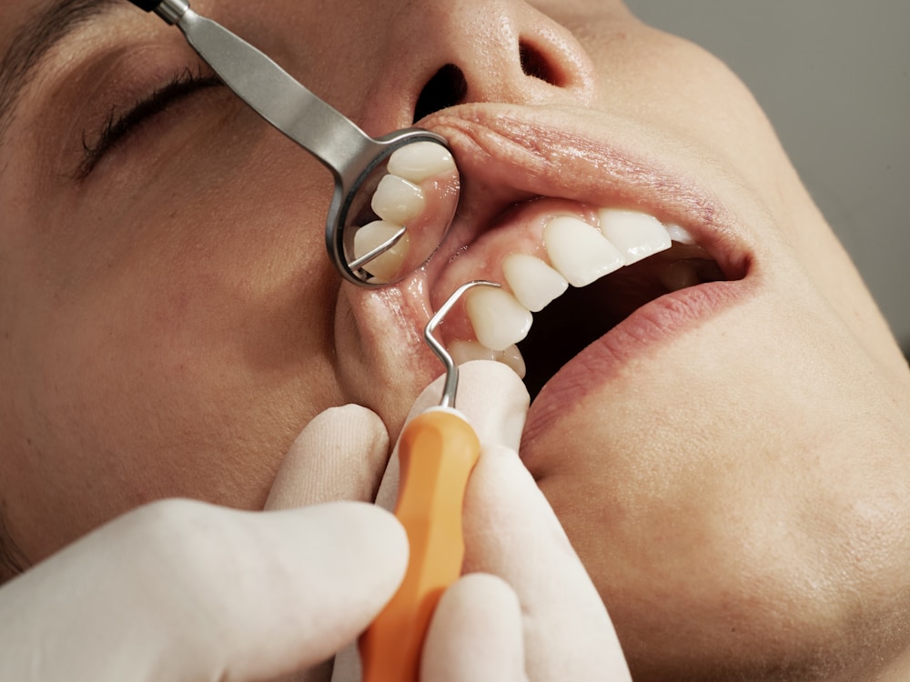 Dentist carefully examining a patient’s teeth
