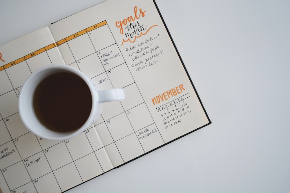 A cup of tea beside a journal for a quiet daily pause