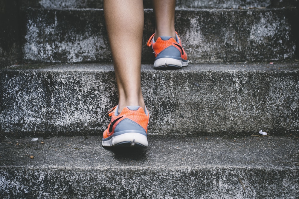Person taking a step up an outdoor staircase